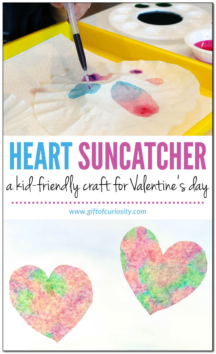 Heart suncatcher craft for Valentine's Day made from coffee filters and liquid watercolor paints #ValentinesDay #hearts || Gift of Curiosity