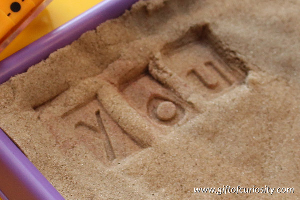 Spelling practice in kinetic sand | Keep your spelling practice fresh! Mix things up by having your child stamp their spelling words in kinetic sand for an entirely new experience || Gift of Curiosity