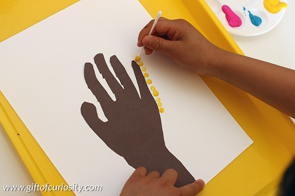 Make beautiful handprint dot trees using children's handprints to create trunks for the tree. This fine motor art project will show off children's unique hand print and creative style. | #artsandcrafts #handsonlearning #finemotor #giftofcuriosity || Gift of Curiosity