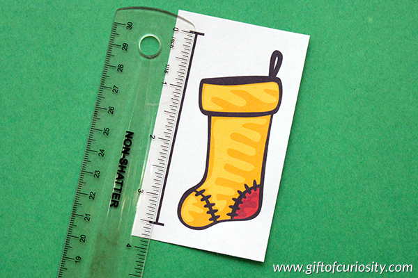 This pack of 25+ themed measurement activities for children in grades 1-3 helps children practice measuring objects in either inches or centimeters. Plus, after recording their measurements on the included worksheet, children sort the objects by height. So many great math skills in one engaging activity! #giftofcuriosity #measurement #math #STEM #STEAM #printables #1stgrade #2ndgrade #3rdgrade || Gift of Curiosity