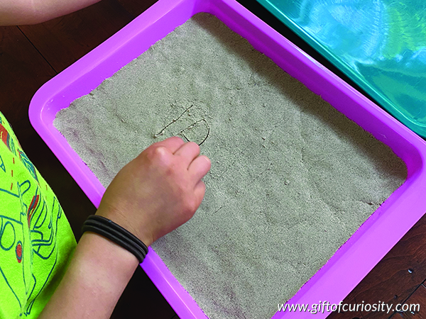 Multi-sensory spelling stations: use a toothpick to write words in sand